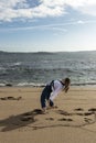 woman cartwheeling in kimono on the beach