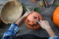 Woman carve pumpkins for Halloween outdoor