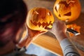 Woman carving Halloween pumpikn; Festive lifestyle concept