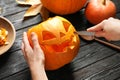 Woman carving Halloween pumpkin head jack Royalty Free Stock Photo