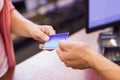 Woman at cash register paying with credit card Royalty Free Stock Photo