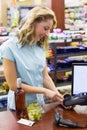 Woman at cash register paying with credit card Royalty Free Stock Photo