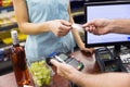 Woman at cash register paying with credit card Royalty Free Stock Photo