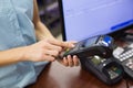 Woman at cash register paying with credit card Royalty Free Stock Photo