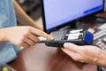 Woman at cash register paying with credit card Royalty Free Stock Photo