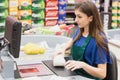 Woman cashier beeping an item