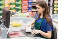Woman cashier beeping an item Royalty Free Stock Photo