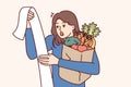 Woman with cashier check and bag of groceries surprised by increase in prices due to inflation Royalty Free Stock Photo