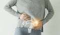 Woman in casual clothes suffering from indigestion pain, highlighted visualisation of uterus