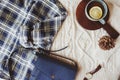 Woman casual fall stylish clothes flat lay with plaid shirt, knitted sweater, cross body bag and cup of tea. Royalty Free Stock Photo