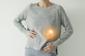 Woman in casual grey clothes suffering from indigestion pain, highlighted visualisation of spleen