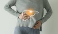 Woman in casual grey clothes suffering from indigestion pain, highlighted  visualisation of liver Royalty Free Stock Photo