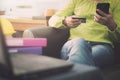 Woman in casual shirt paying with credit card online while making orders via the Internet. Royalty Free Stock Photo