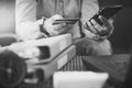 Woman in casual shirt paying with credit card online while making orders via the Internet. Black and white picture. Royalty Free Stock Photo