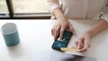 Woman in casual shirt paying with credit card online while making orders via the Internet. Successful black businesswoman making Royalty Free Stock Photo