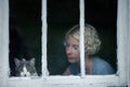 Woman and Cat Looking at the Rainy Weather By the Window Royalty Free Stock Photo