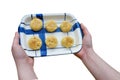 Woman is catch ceramic tray and a cookie is placed above. Royalty Free Stock Photo