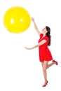 Woman catching big yellow balloon isloated on white background Royalty Free Stock Photo