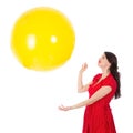 Woman catching big yellow balloon isloated on white background Royalty Free Stock Photo