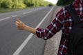 Woman catching car on road, closeup. Hitchhiking trip Royalty Free Stock Photo