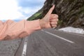 Woman catching car on road, closeup. Hitchhiking trip Royalty Free Stock Photo