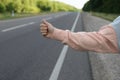 Woman catching car on road. Hitchhiking trip Royalty Free Stock Photo