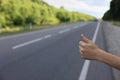 Woman catching car on road. Hitchhiking trip Royalty Free Stock Photo