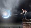 Woman catching moon Royalty Free Stock Photo