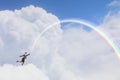 Woman catching rainbow