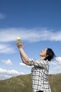 Woman catching tennis ball in sand dunes