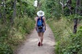 Woman, caucasian beauty style, blonde girl backpacking on a path through the forest