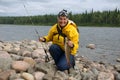 Woman caught a big lenok in wild Siberian river.