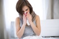 Woman caught cold. sneezing into tissue
