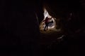 Woman caver spelunker exploring the cave Royalty Free Stock Photo