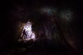 Woman caver spelunker exploring the cave Royalty Free Stock Photo