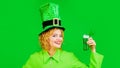 Woman celebrate Patricks Day. Beautiful girl in leprechaun hat drinking green beer in bar. Patrick Day pub party Royalty Free Stock Photo