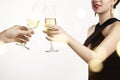 Woman celebrating and clang glasses together with champagne. White background with flares