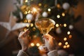 Woman celebrating with fireworks and champagne glass against christmas tree lights. Happy New Year Royalty Free Stock Photo