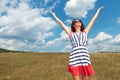 Woman celebrating freedom in the middle of a field Royalty Free Stock Photo