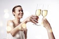 Woman celebrating and says cheers at the party with a glass of champagne. Clang glasses together