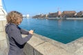 Woman with cell phone on the embankment