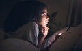 Woman, cellphone and bed in night, reading or texting for chat, blog or social media post in apartment. Girl, smartphone