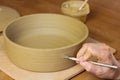 Woman ceramist attaching handle to the pot in pottery class. Potter workshop in ceramic studio Royalty Free Stock Photo