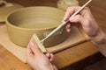 Woman ceramist attaching handle to the pot in pottery class. Potter workshop in ceramic studio Royalty Free Stock Photo