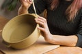 Woman ceramist attaching handle to the pot in pottery class. Potter workshop in ceramic studio Royalty Free Stock Photo