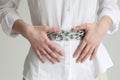 Woman with chain belt suffers from heaviness in stomach