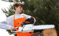 A woman with a chainsaw