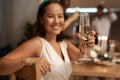 Woman, champagne and hand for toast in portrait, dinner or party for new year with friends, family or team. Happy