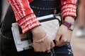 Woman with Chanel small white bag and Hermes watch before Salvatore Ferragamo fashion show, Milan Fashion