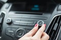 Woman changing frequency on car radio Royalty Free Stock Photo